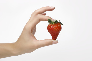 strawberry in woman hand