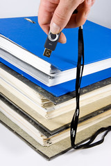 Stack of file folders with memory stick