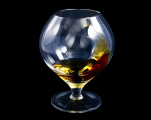 Decorated cognac glass, filled with alcohol.