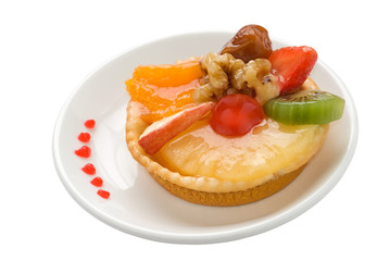 Isolated cup cake with fruit and cream on a plate.