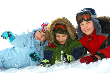 Fototapeta na wymiar Kids laying in winter snow