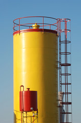 Yellow tank in refinery or factory