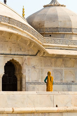 An indian woman dressed in a yellow sari at Amber fort