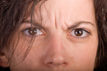closeup of brunette woman looking seriously at the camera