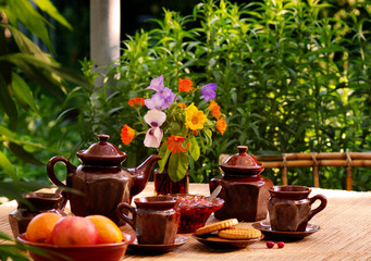 evening tea drinking with strawberry jam in summer garden