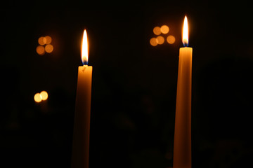 Two candles burning at night