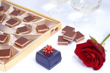 Valentine table with rose, box of chocolates and gift box
