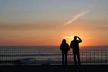 man and woman silhouette in sunset