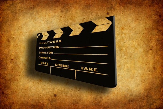 Cinema Clapboard Over Old And Worn Paper Texture