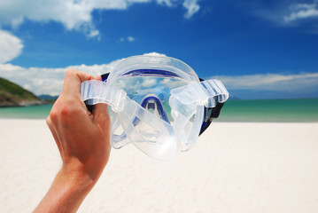 Snorkel equipment against beach and sky