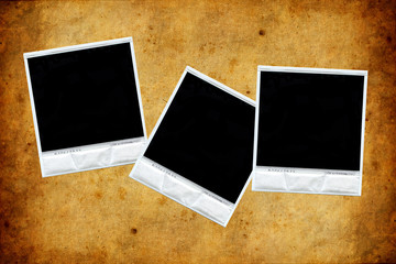 set of three polaroids over old paper texture