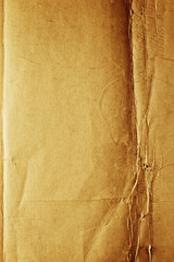 Yellow-brown messy rough old paper with cracks and folds