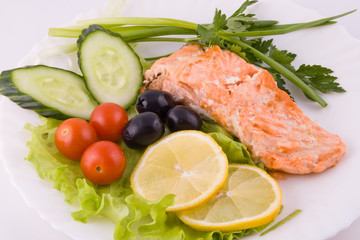 Stake from a trout with vegetables and lemon