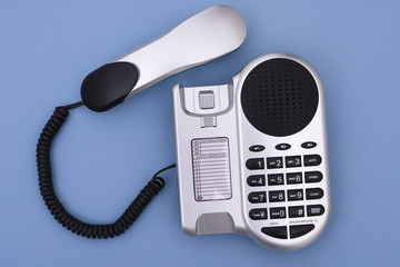 Telephone off the hook on blue background