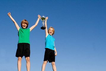 Obraz na płótnie Canvas children winners with sports cup or trophy