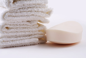 White towels and soap on a white background