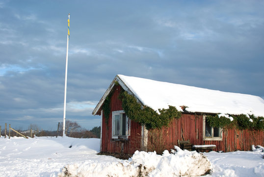 red cottage in snow