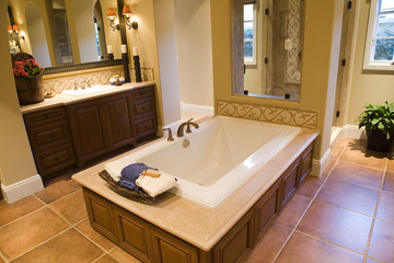 Designer bathroom with a modern tub and tile floor.