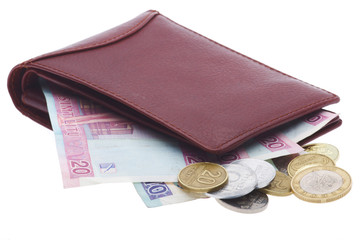 brown leather wallet with banknotes and coins sticking out