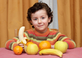 Fototapeta premium Adorable child eating fruit - focus in the face -