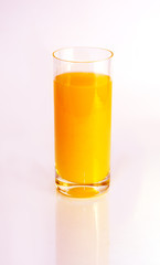 Glass of orange juice on white background