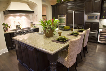 Luxury home kitchen with a granite island.