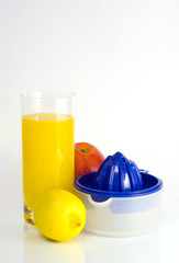 Glass of orange juice, squeezer on white background