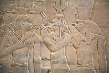 wall with a relief of an egyptian scene with two gods an a king
