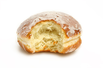 Delicious donut with a chunk bitten out isolated on white