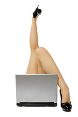 sexy legs with laptop isolated on white