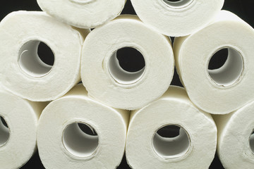 a lot of toilet papers on black background