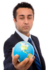 senior businessman holding a mini globe, shallow dof