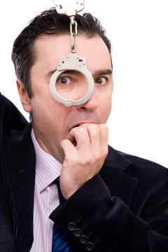 worried businessman portrait with handcuffs on white background