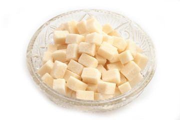On a photo sugar lump sugar in a plate. 