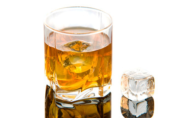 Whiskey in glass with ice cubes