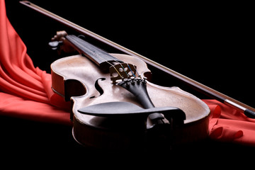 old violin with fiddlestick on folded scarlet silk © Oleg Kozlov