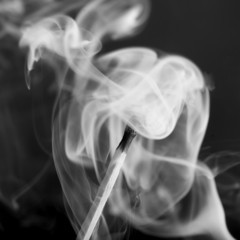 close up of smoke swirling around match