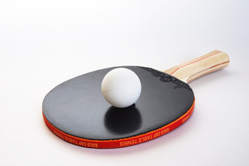 Black ping-pong paddle with the ball
