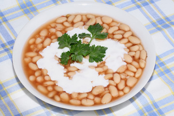 Plate with bean on the tablecloth