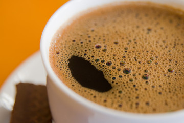 coffe cup and biscuit in background