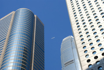 Fototapeta na wymiar a plane flys past hong kong sky scrapers