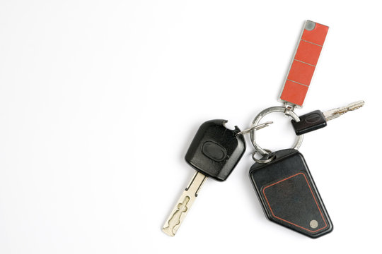 Old Car Keys And Remote Control On A White Background.