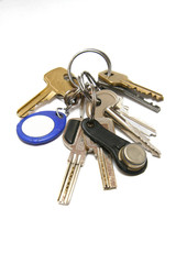 Metal keys with a plastic charm on a white background.