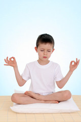 6 years old boy relaxing on blue background