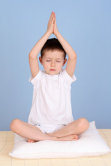 6 years old boy relaxing on blue background