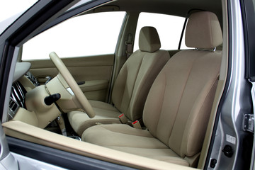 Front seats of a modern car, light leather.
