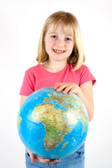 A young girl holding a globe against a white background