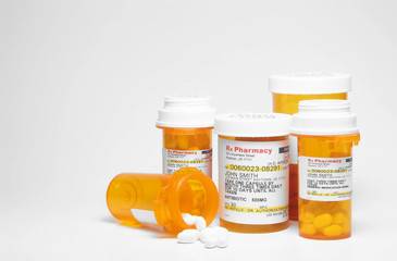 Prescription pills in plastic medicine bottles. - obrazy, fototapety, plakaty