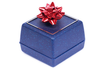 Blue gift box for jewels with red ribbon on white background
