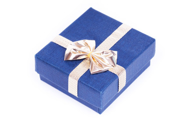 Blue gift box for jewels with golden ribbon on white